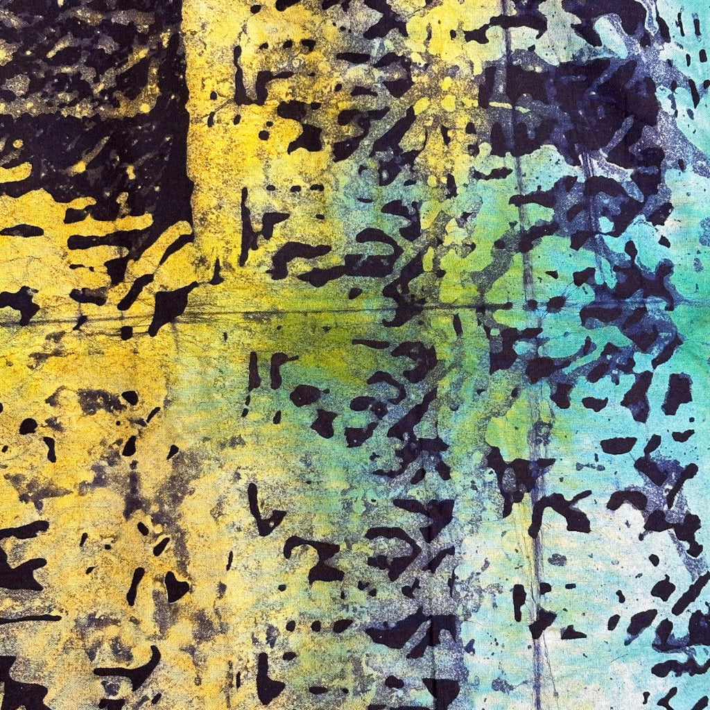 The African Fabric Wax Batik #2019 features a textured abstract pattern on cotton, blending yellow, green, and blue hues with black splatter and grid-like motifs. Its reminiscent of hand-stamped batik, offering a dynamic and chaotic visual effect.
