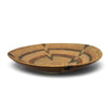 A hand-woven basket bowl with a geometric pattern in natural tan, brown, and muted red, shown on a white background with a soft drop shadow.