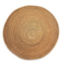 A round natural woven placemat or rug in a light tan color, featuring concentric circular patterns and a textured basket-weave design, shown on a solid white background.